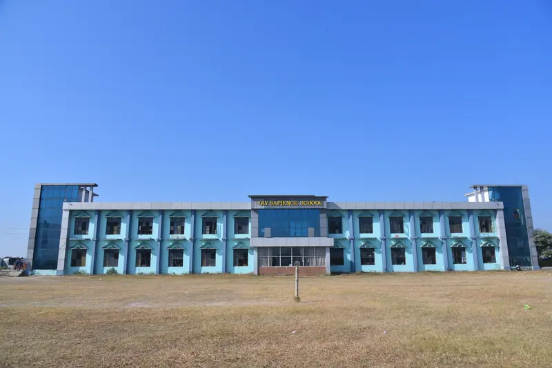 The two-storey school building across the playing ground