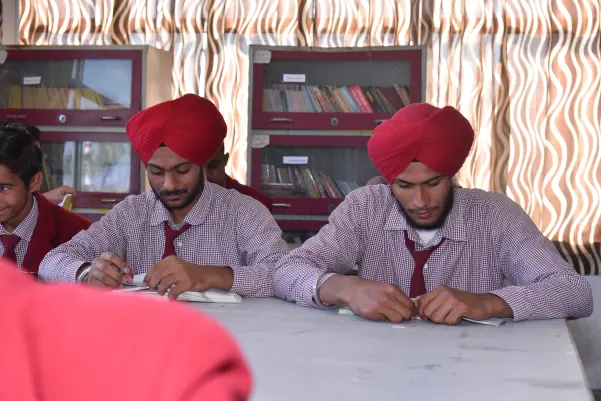 Two students reading in the library