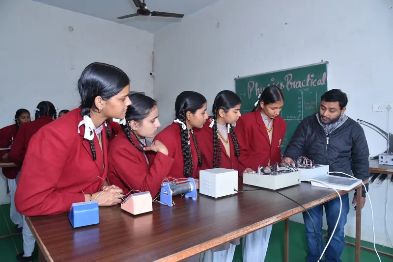 Girls in the physics practical lab with their teacher