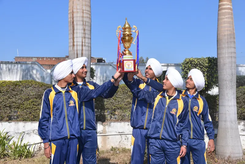 The boys' team lifting their trophy
